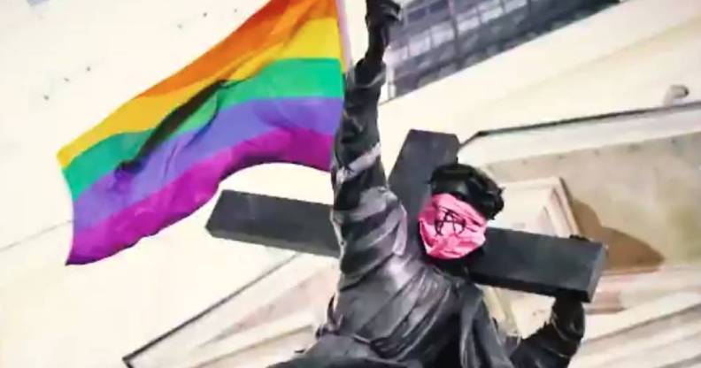 Jesus statue with rainbow flag and anarchist bandana