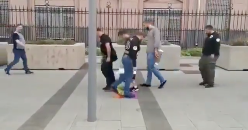 Russian straphangers took time out of their busy schedules to briefly queue up and wipe their feet on an LGBT+ Pride Flag. Classy. (Screen capture via Twitter)