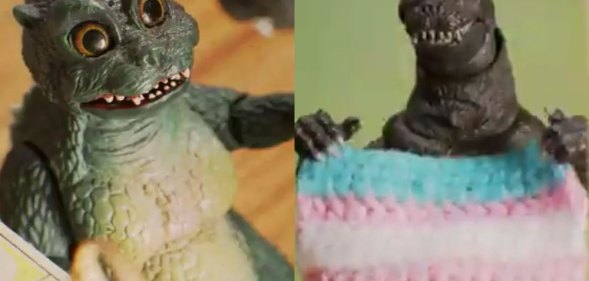 Godzilla holding a trans flag