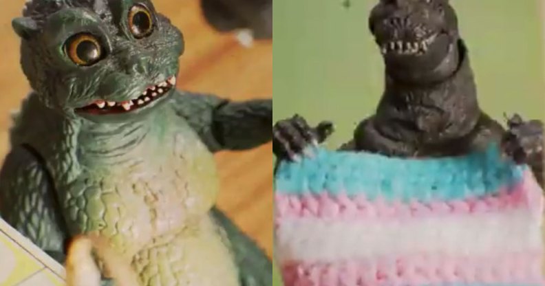 Godzilla holding a trans flag