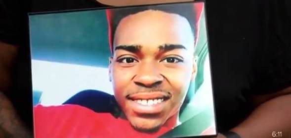 Hands holding a photo of Malik Jackson