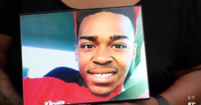 Hands holding a photo of Malik Jackson