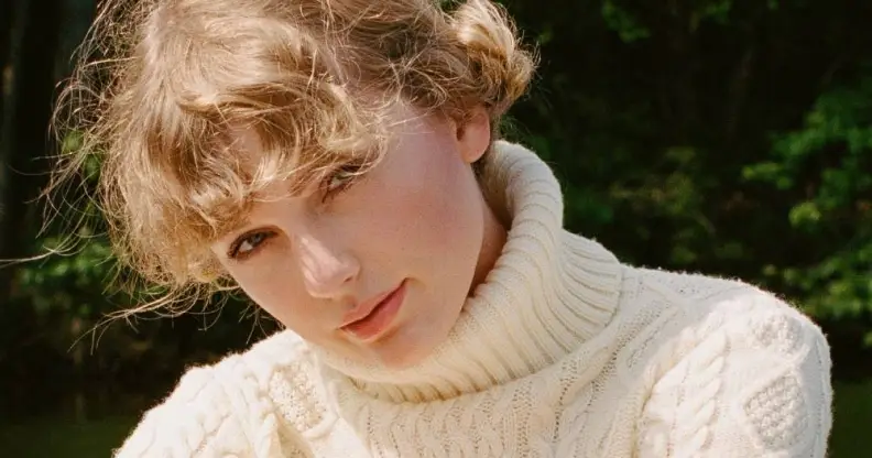 Taylor Swift wearing a cream roll neck jumper with soft curls (mid shot) queer betty