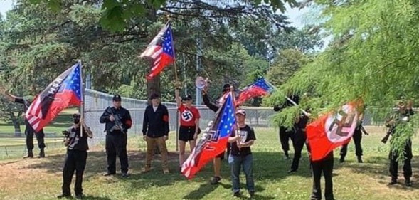 Neo-Nazi thugs march with swastikas while chanting 'f**k you f****ts'
