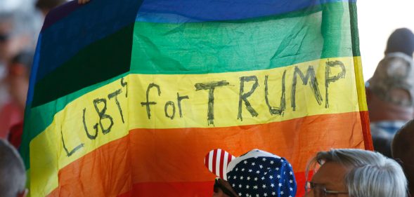 Supporters hold up an LGBT+ Pride flag for Republican presidential candidate Donald Trump. (George Frey/Getty Images