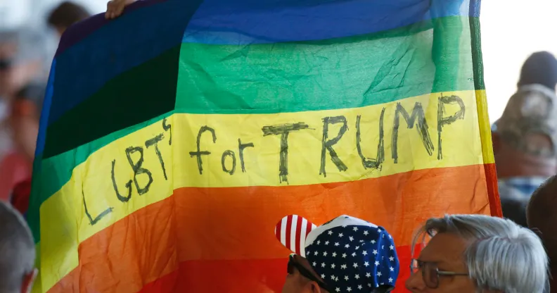 Supporters hold up an LGBT+ Pride flag for Republican presidential candidate Donald Trump. (George Frey/Getty Images