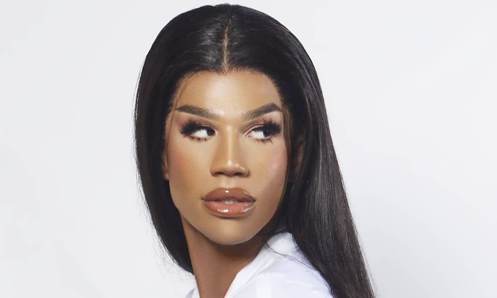 A tight crop of Naomi Smalls' face. Her hair is long, her mug is beat, her eyes looking to the right