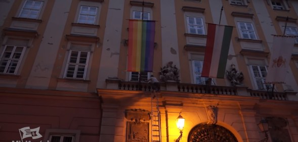 A far-right Hungarian politician has been arrested after using a ladder to climb the front of Budapest City Hall to pull down a Pride flag.