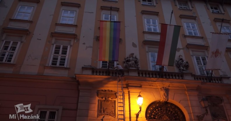 A far-right Hungarian politician has been arrested after using a ladder to climb the front of Budapest City Hall to pull down a Pride flag.