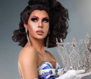 Trinity the Tuck holding her Drag Race crown