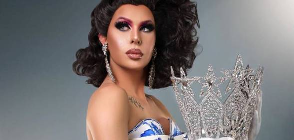 Trinity the Tuck holding her Drag Race crown