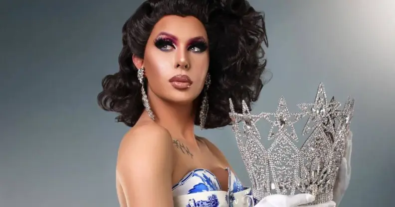 Trinity the Tuck holding her Drag Race crown