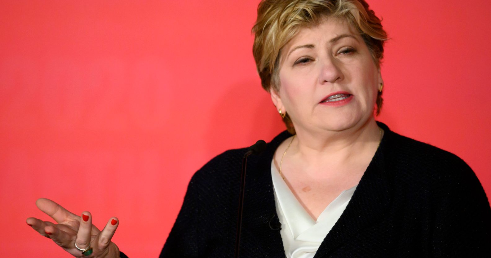 A cut-out of Emily Thornberry, Labour's shadow international trade secretary and MP for Islington South and Finsbury, wearing a black cardigan over a white top as she gestures with her right hand against a pink background