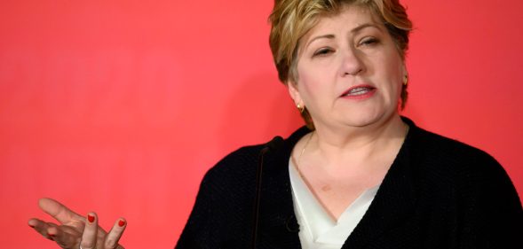A cut-out of Emily Thornberry, Labour's shadow international trade secretary and MP for Islington South and Finsbury, wearing a black cardigan over a white top as she gestures with her right hand against a pink background