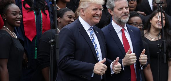 Jerry Falwell Jr, the-president of Liberty University, poses for photos with Donald Trump in 2017