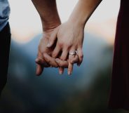A close-up image of two people holding hands