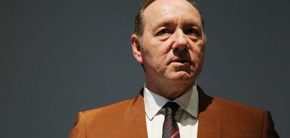 Kevin Spacey in an orange-brown suit