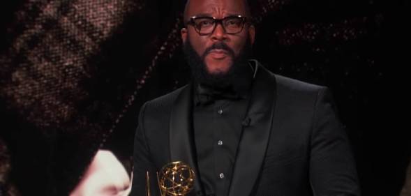 Tyler Perry holding his Emmy Award