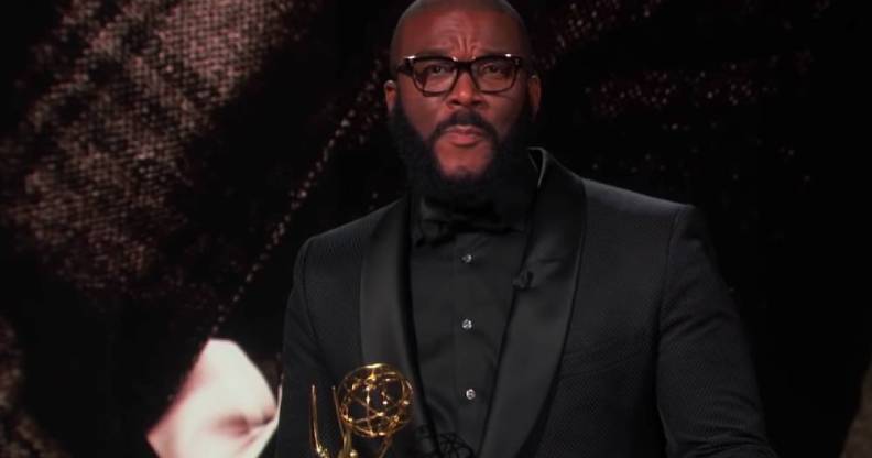 Tyler Perry holding his Emmy Award