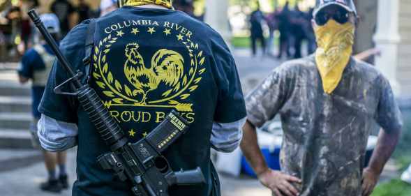 Armed members of the far-right Proud Boys group. (Nathan Howard/Getty Images)