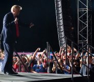 US President Donald Trump dances as he leaves a Make America Great Again rally as he campaigns at Orlando Sanford International Airport in Sanford, Florida, October 12, 2020.