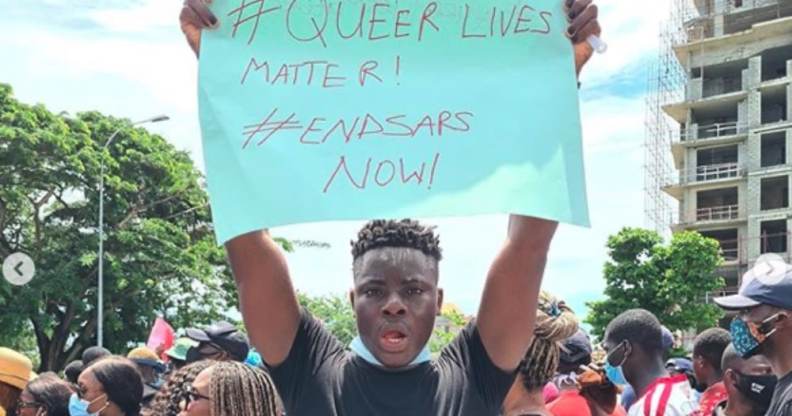 Matthew Blaise holding a placard reading 'Queer Lives Matter! End SARS now!'