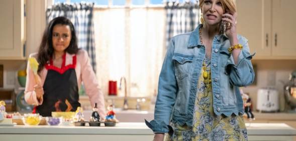 Jane Lynch wearing a denim jacket and classic short, spiky Karen hairstyle