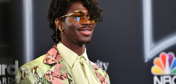 Lil Nas X in a curly wig at the Billboard Music Awards