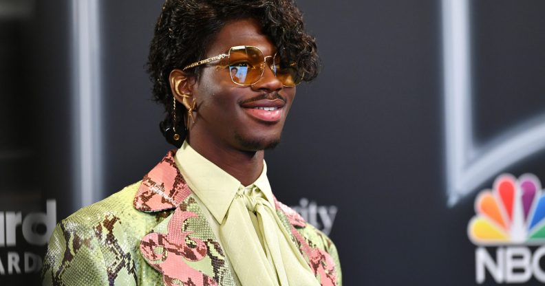 Lil Nas X in a curly wig at the Billboard Music Awards