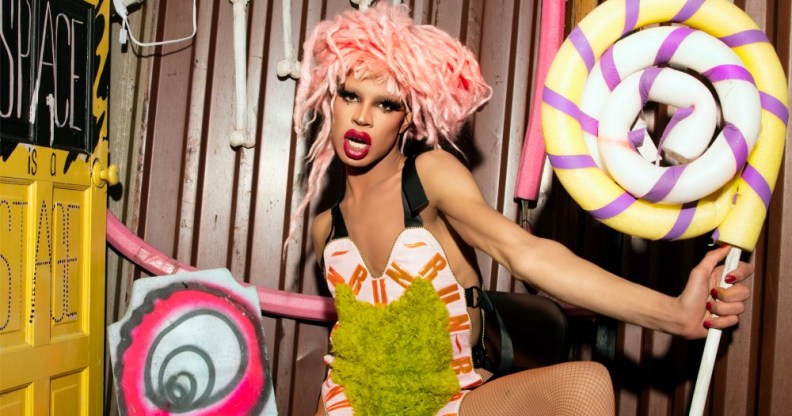 Yvie Oddly holding a big swirly lollipop
