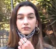 Eva Vidosola pulling down her face mask to reveal a bloodied lip