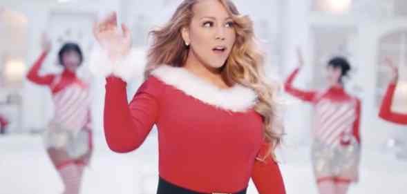 Mariah Carey performs 'All I Want For Christmas Is You' in a Santa-themed dress with festive back-up dancers behind her