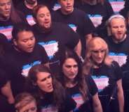 Choir members wearing t-shirts with a heart on in the colours of the trans flag