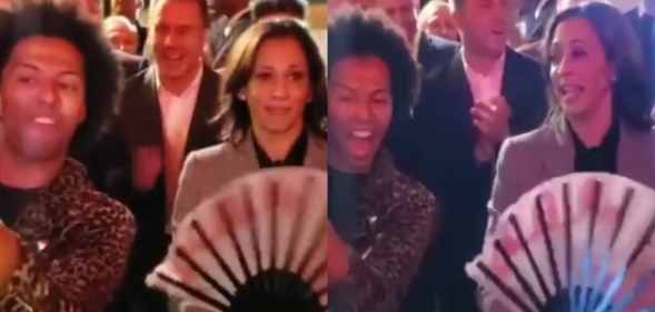 Kamala Harris holding a large fan while Shangela takes a selfie