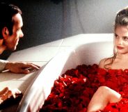 Kevin Spacey leering over a naked young woman in a bath filled with flowers