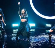 Little Mix dancing in black outfits against a neon light