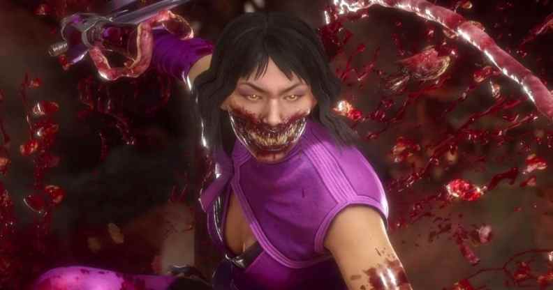 Mileena, wearing a purple top bearing sharp, alien teeth