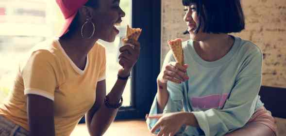 Two women eating ice cream cones