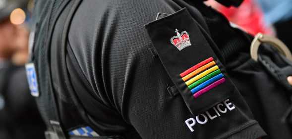 A Met police officer wearing rainbow epaulettes at Pride in London