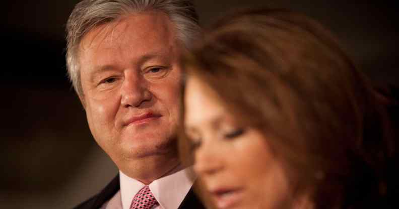 Marcus Bachmann wears a suit and red tie