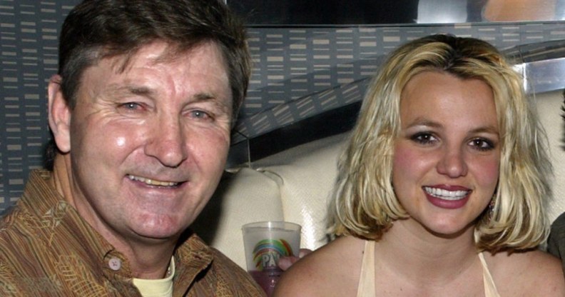 Jamie Spears in a brown jacket and Britney Spears in a vest smile at the camera