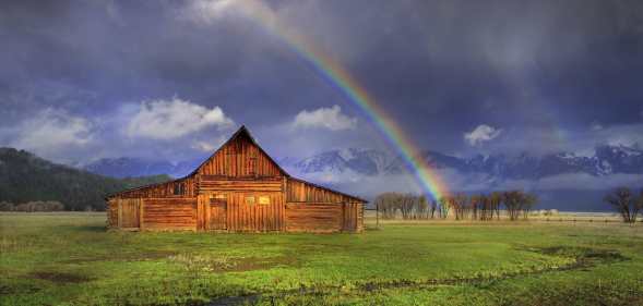 A rainbow over a barn in Wyoming