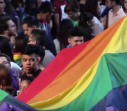 Protesters holding a giant Pride banner