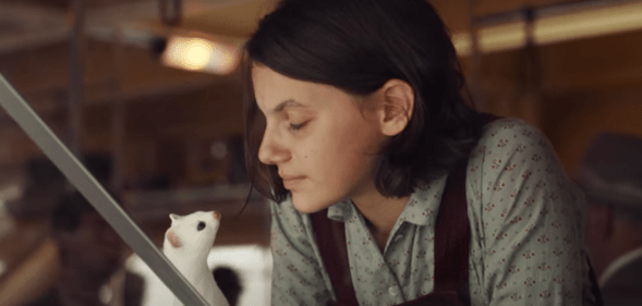 Lyra in His Dark Materials with her daemon