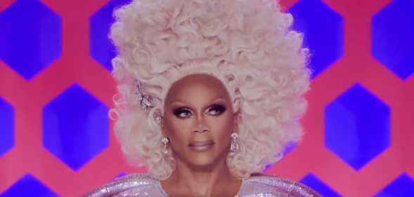 RuPaul in a tall curly blonde wig