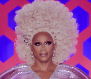 RuPaul in a tall curly blonde wig