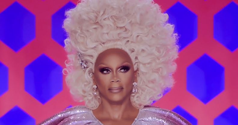 RuPaul in a tall curly blonde wig
