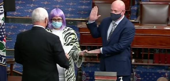 Bisexual senator Kyrsten Sinema (C) holds the Bible as Mark Kelly (R) is sworn in by Mike Pence. (Twitter)