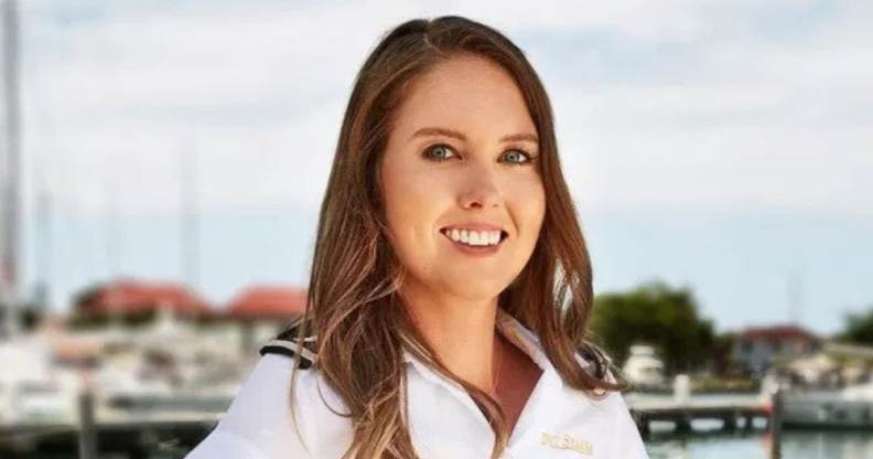 zzy Wouters in a white shirt standing on the docks