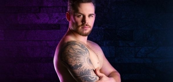 Matthew Camp, topless. arms folded